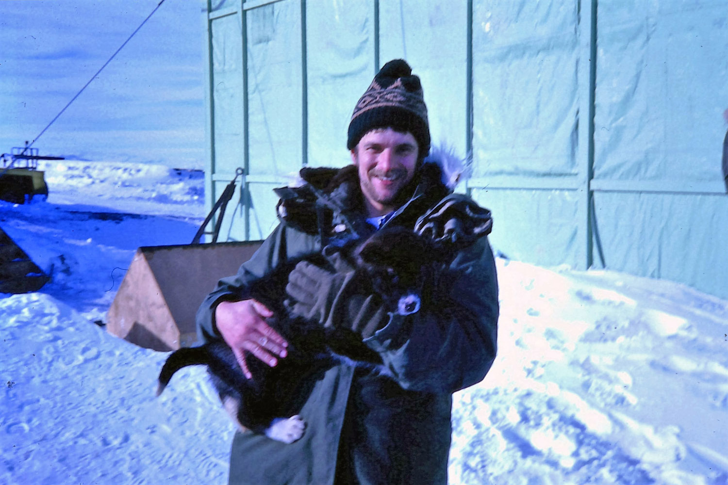 Roly Hermans at Scott Base with a sled-dog pup