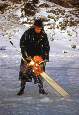 Tony Walker cutting a hole in the sea-ice